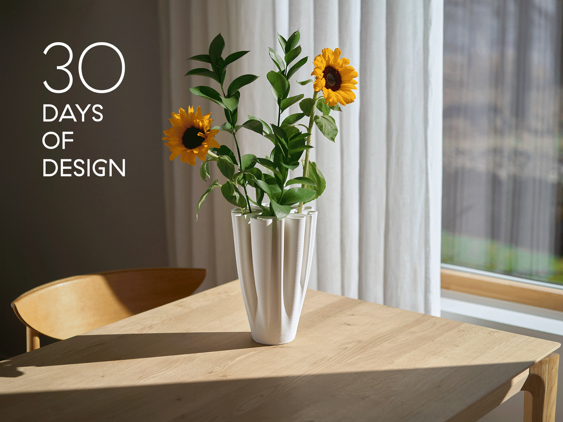 Weiße, gefaltete Vase mit Sonnenblumen auf einem Holztisch. Der Text lautet '30 DAYS OF DESIGN'.