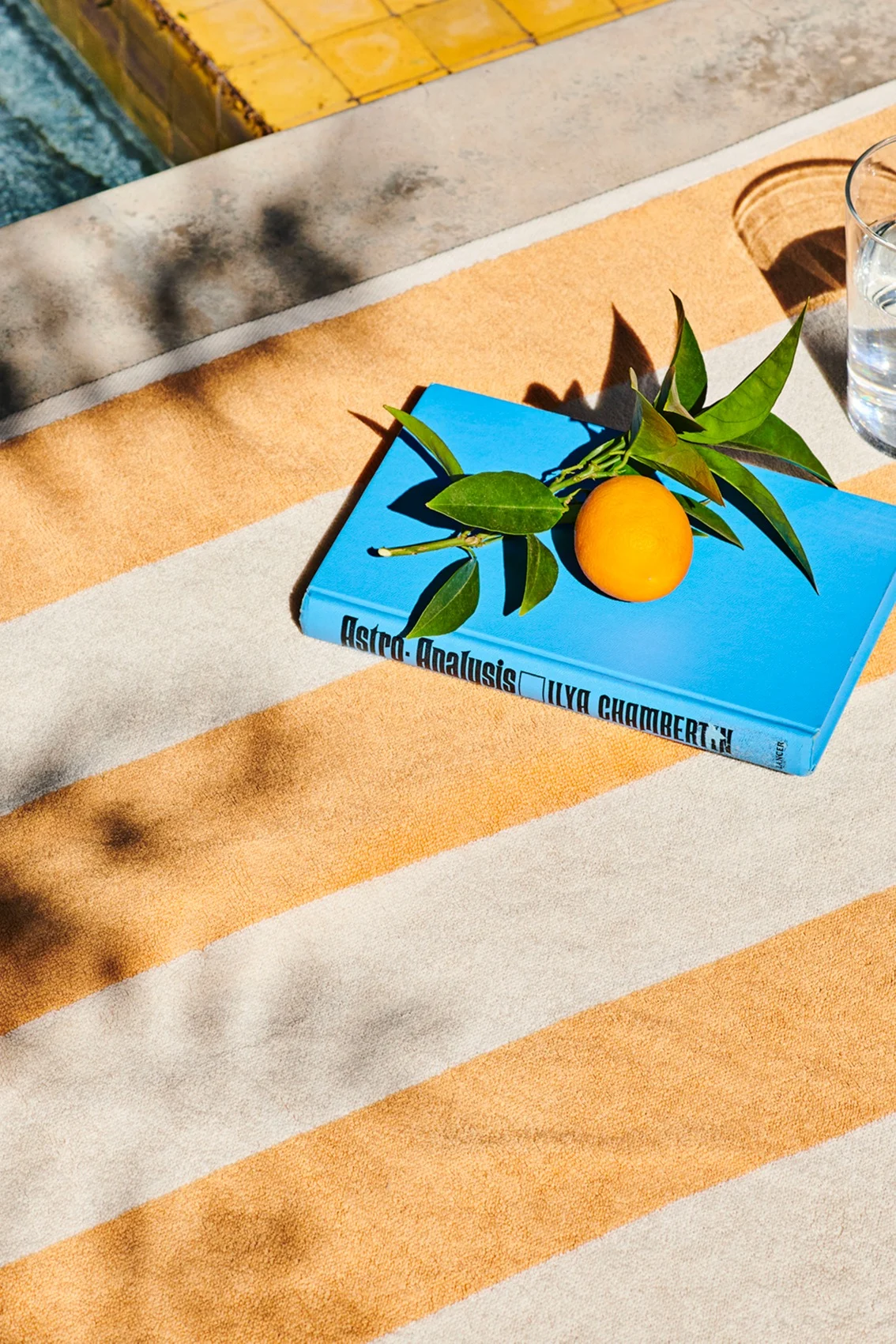 Das gelb-weiß gestreifte Badetuch Stripes von HAY erinnert an sonnige und warme Breitengrade.