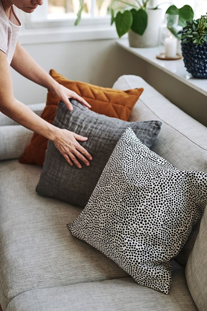 Das Sofa ist mit Kissen von Marimekko, Himla und Northern in einem stilvollen Design ausgestattet. 