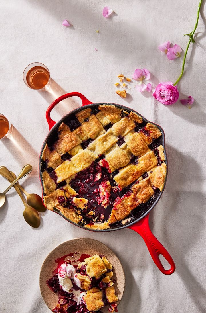 In der roten tiefen Pfanne von Le Creuset wurde ein Kirschkuchen zubereitet.