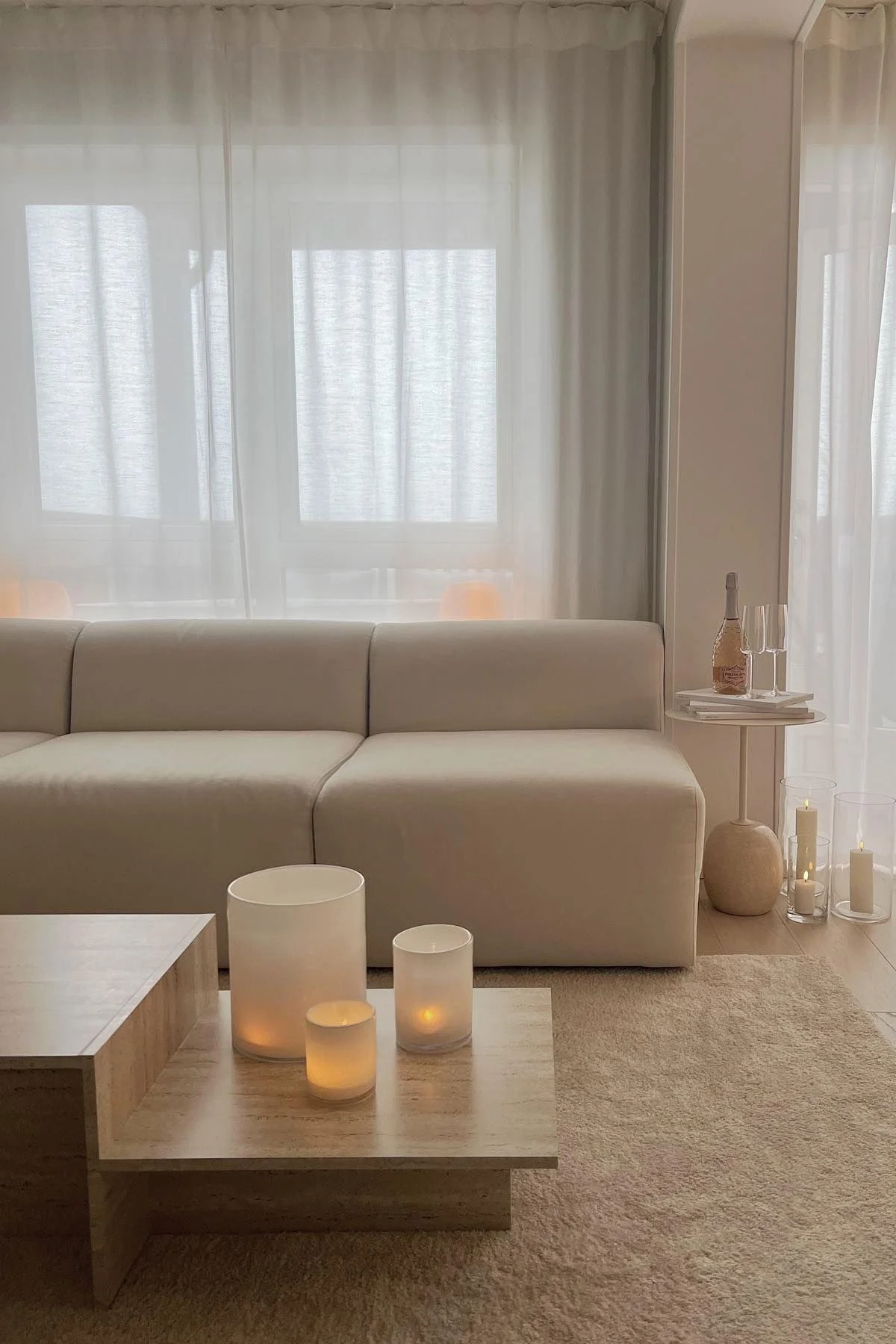 Mehrere Calore Windlichter von Byon in verschiedenen Größen stehen auf dem Beistelltisch im beigen Wohnzimmer von @ayasinteriorworld.