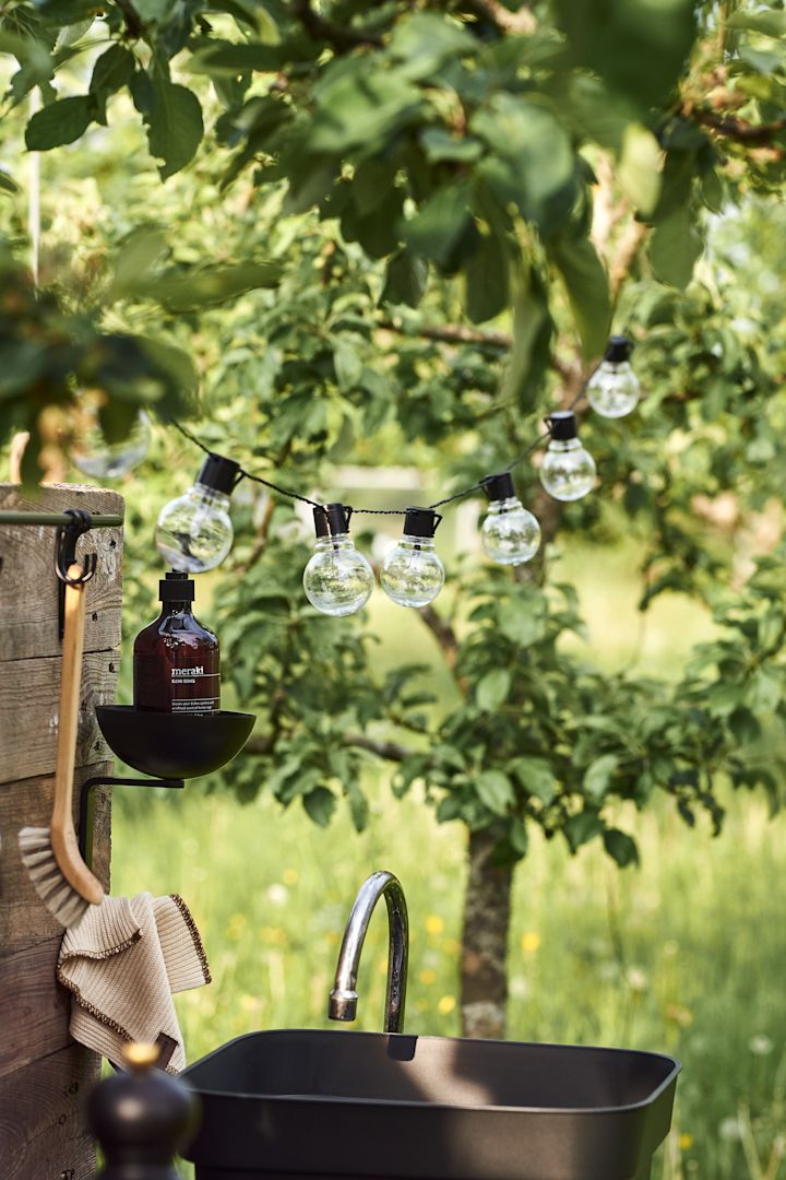 Outdoor Küche selber bauen: Eine Lichterkette verleiht Ihrer Outdoor-Küche einen gemütlichen Charakter und spendet auch nach Sonnenuntergang ausreichend Licht.