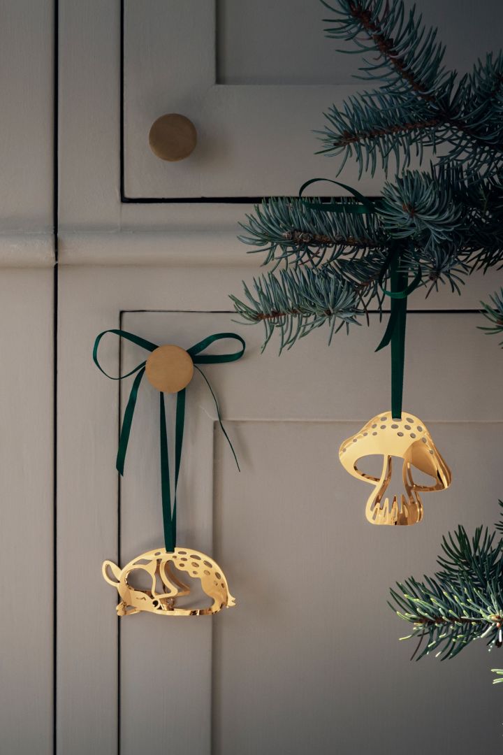 Der diesjährige Weihnachtsschmuck 2023 glänzt, wie diese vergoldeten Weihnachtsanhänger von Georg Jensen mit Reh- und Pilzmotiven.