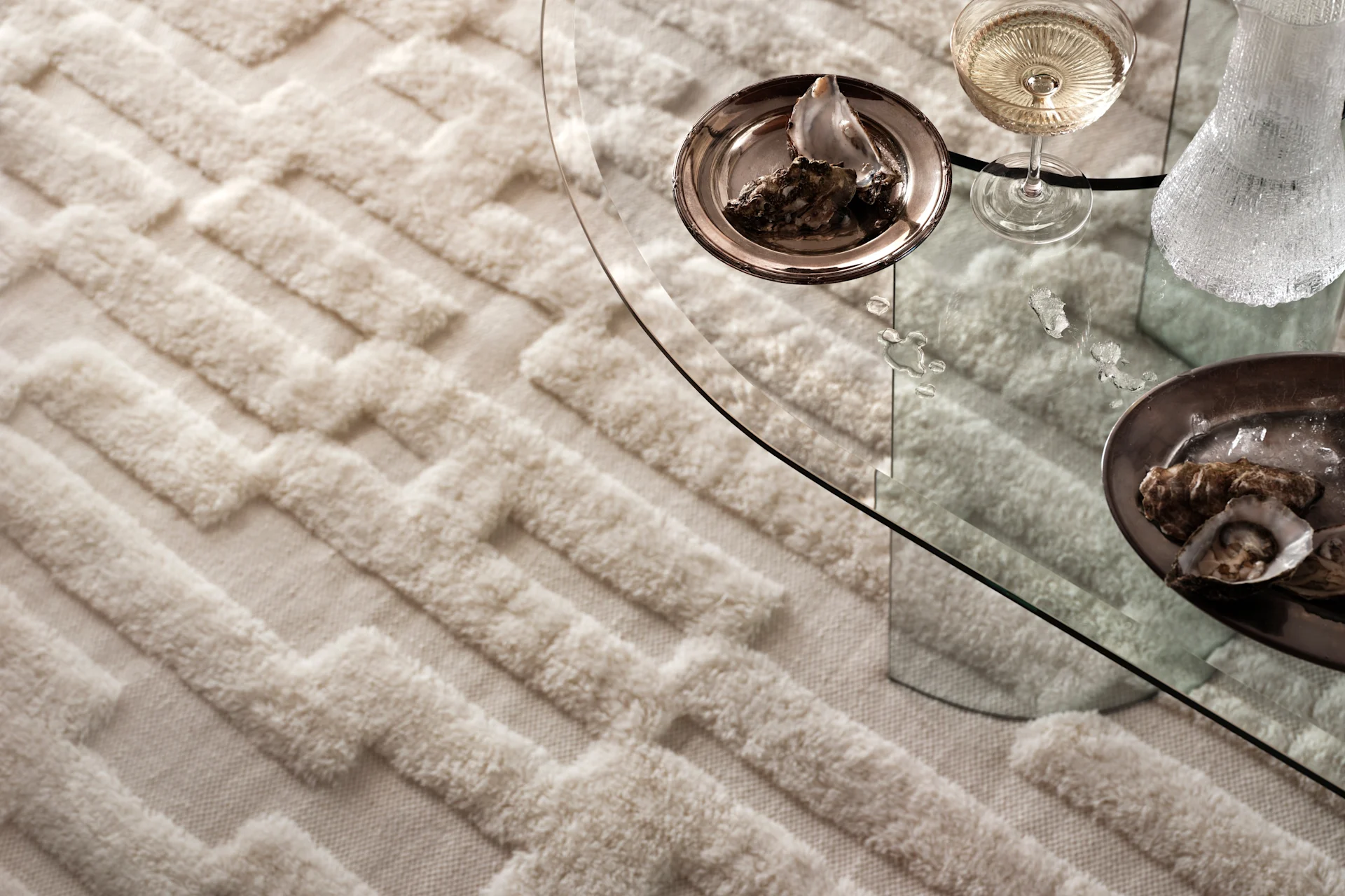 Ein weißer Wollteppich mit einem erhabenen Muster der schwedischen Designmarke Tinted Objects. 