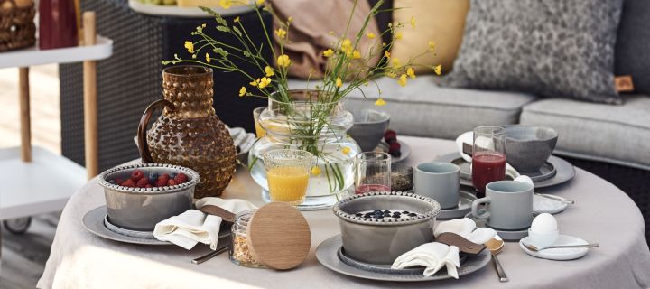 Ein luxuriöses und gemütliches Hotelfrühstück zu Hause wird auf der Terrasse mit Smoothie-Bowls, Kaffee und Säften serviert.