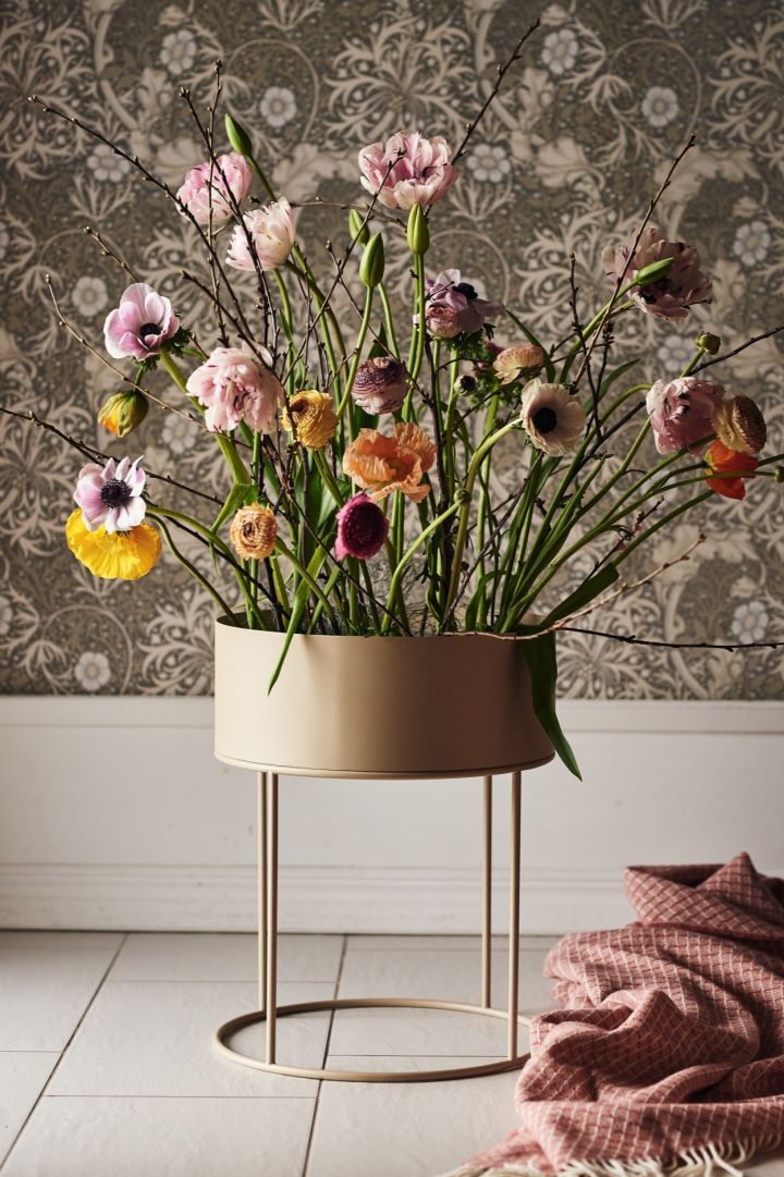 Frühlingserwachen: Ein großes Arrangement frischer Blumen in einer frei stehenden runden Plant box von Ferm Living.