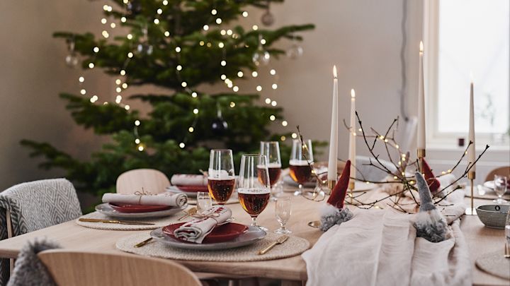 Eine schöne Weihnachtstischdekoration in Rot und bezaubernde Weihnachtsmänner aus Wolle.