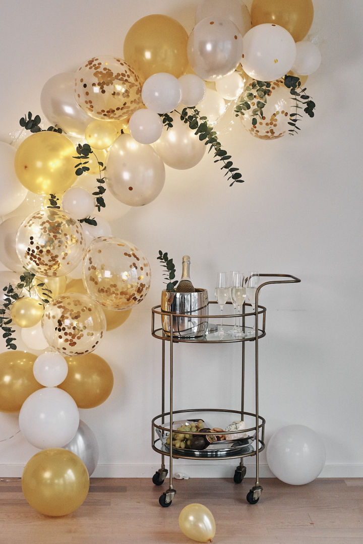 Ideen für Ihre Silvesterparty: Schaffen Sie in einer Ecke einen Platz zum Photos machen und dekorieren Sie diese beispielsweise mit zahlreichen Ballons!